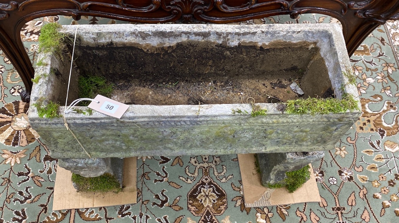 A rectangular reconstituted stone garden planter, width 64cm, depth 23cm, height 47cm